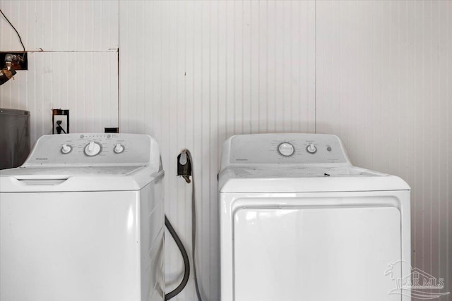 clothes washing area with washing machine and dryer