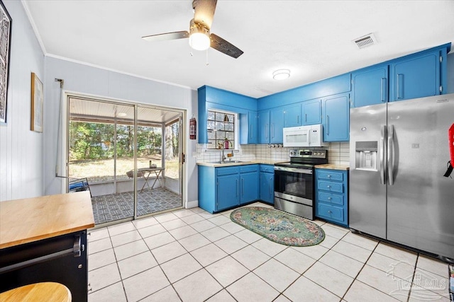 kitchen featuring visible vents, backsplash, blue cabinetry, crown molding, and appliances with stainless steel finishes