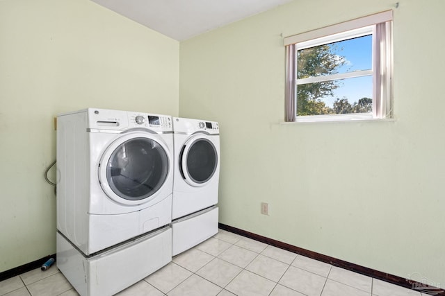 clothes washing area featuring light tile patterned floors and independent washer and dryer