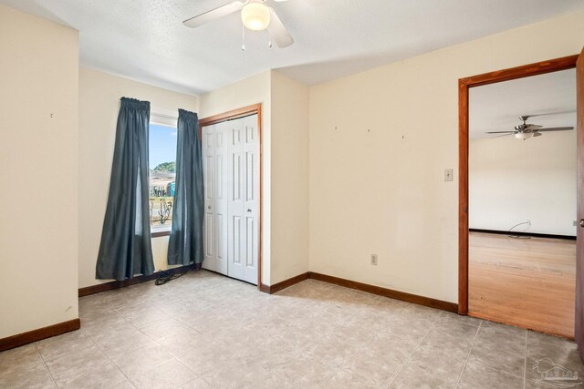 unfurnished bedroom with a closet and ceiling fan