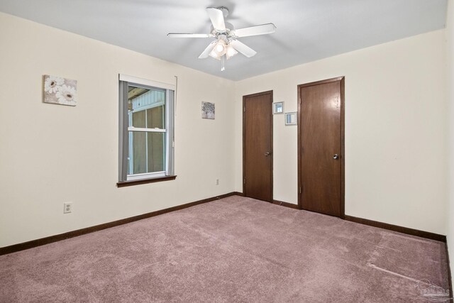 unfurnished bedroom featuring ceiling fan, carpet flooring, and multiple closets