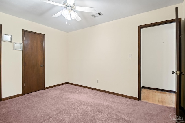 unfurnished room featuring light colored carpet and ceiling fan