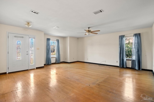 foyer entrance with ceiling fan and light hardwood / wood-style floors