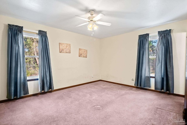 spare room featuring ceiling fan and carpet floors