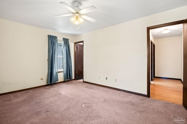 spare room with light carpet and ceiling fan