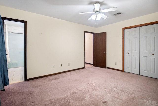 unfurnished bedroom with ceiling fan, a closet, and light carpet