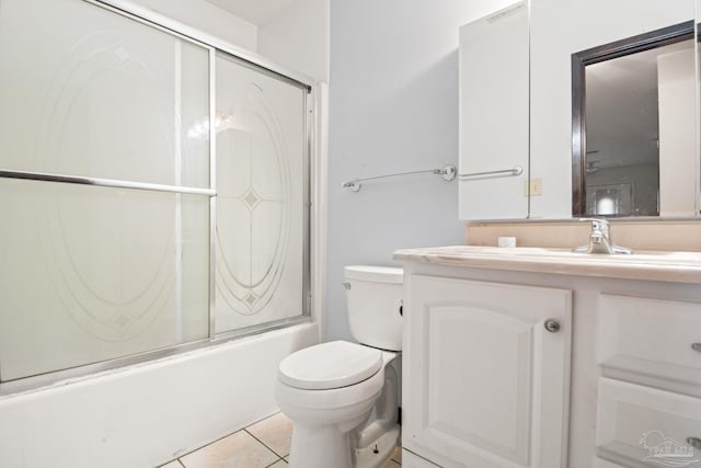 full bathroom with toilet, tile patterned floors, enclosed tub / shower combo, and vanity