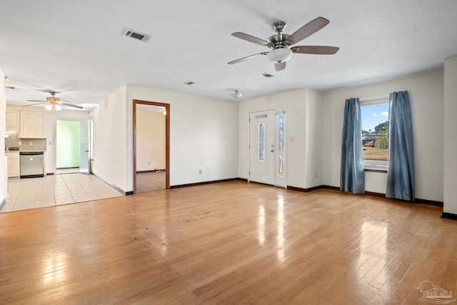 unfurnished living room featuring light hardwood / wood-style flooring and ceiling fan