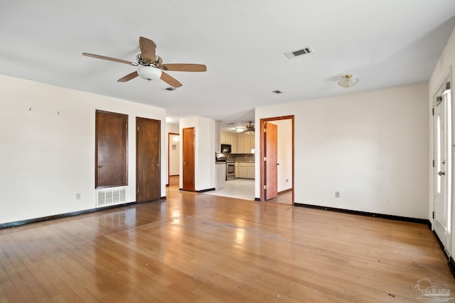 unfurnished living room featuring light hardwood / wood-style floors and ceiling fan