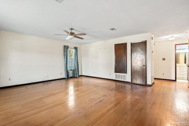 spare room featuring light wood-type flooring and ceiling fan