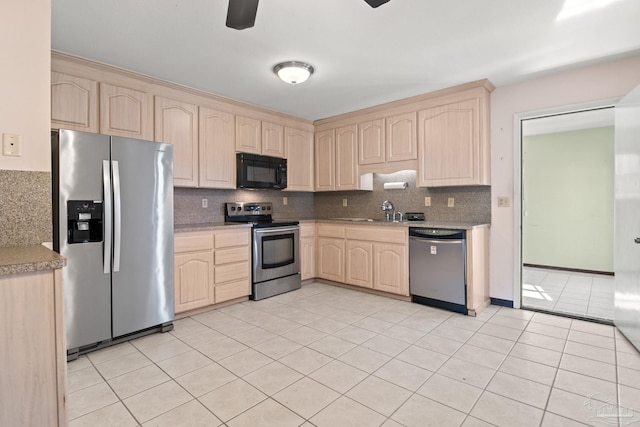 kitchen with tasteful backsplash, light brown cabinetry, light tile patterned floors, and appliances with stainless steel finishes