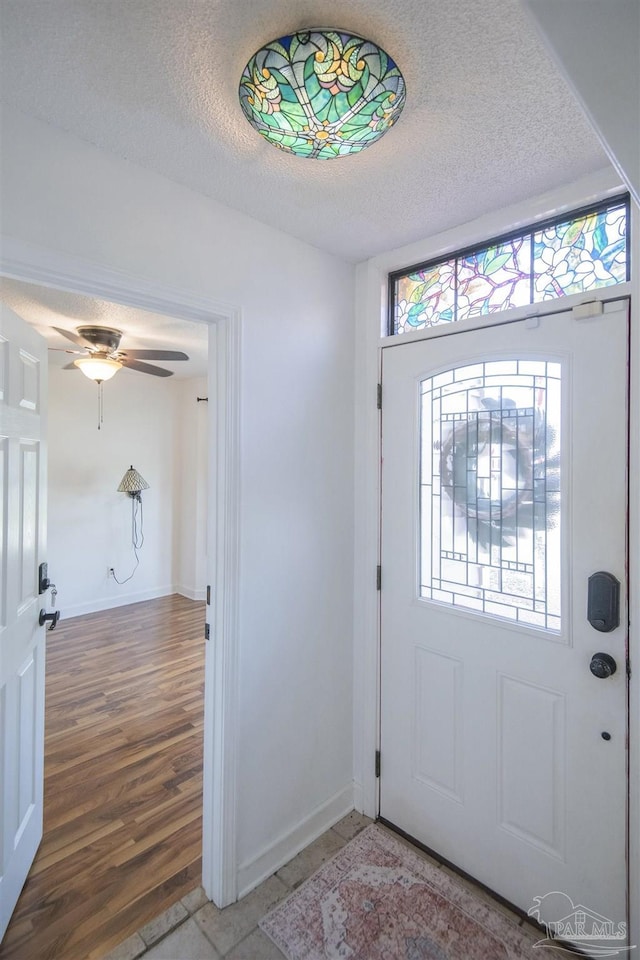 7651 Old Hickory Dr, Pensacola, FL 32507 - foyer with light wood-style flooring, a textured ceiling, and baseboards
