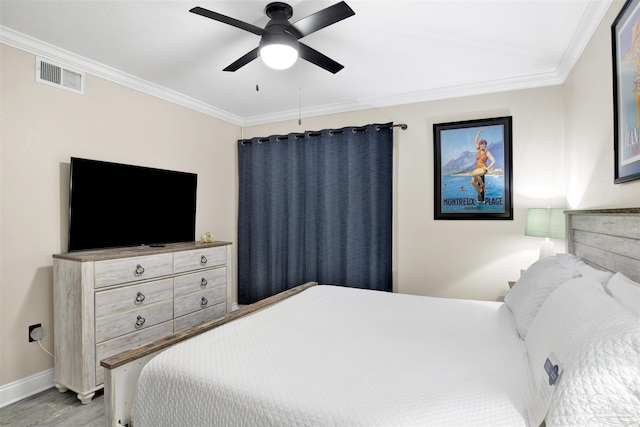 bedroom with ceiling fan, light wood-type flooring, and crown molding