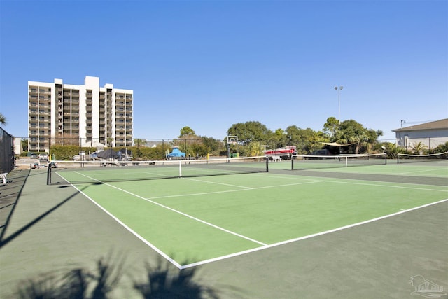 view of tennis court featuring basketball court