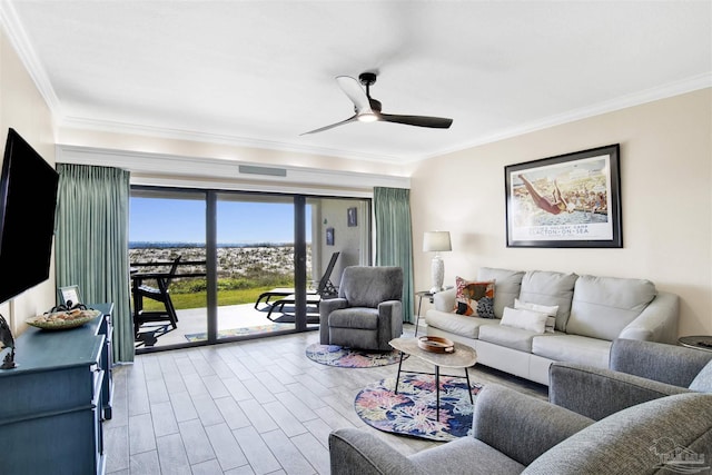 living room featuring ceiling fan, light hardwood / wood-style floors, and crown molding