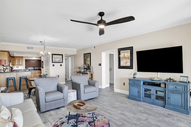 living room with ceiling fan with notable chandelier, light hardwood / wood-style flooring, and ornamental molding