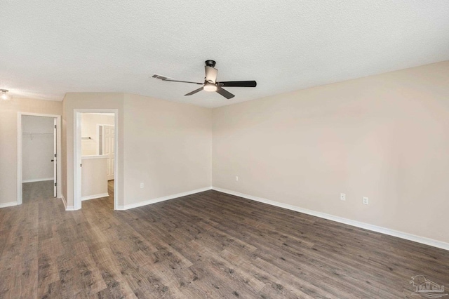 unfurnished room featuring ceiling fan, a textured ceiling, and dark hardwood / wood-style flooring