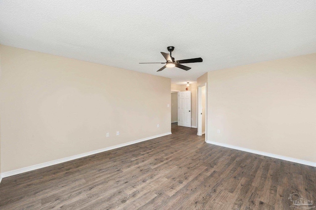 spare room with dark wood-type flooring, ceiling fan, and a textured ceiling