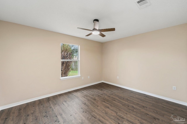 unfurnished room featuring dark wood-type flooring and ceiling fan