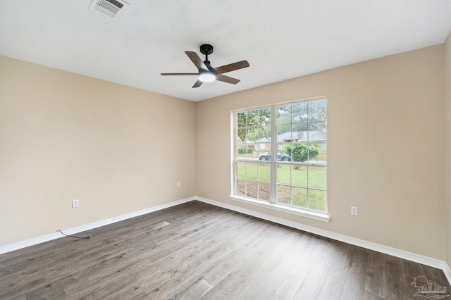 unfurnished room featuring a textured ceiling, dark hardwood / wood-style floors, and ceiling fan