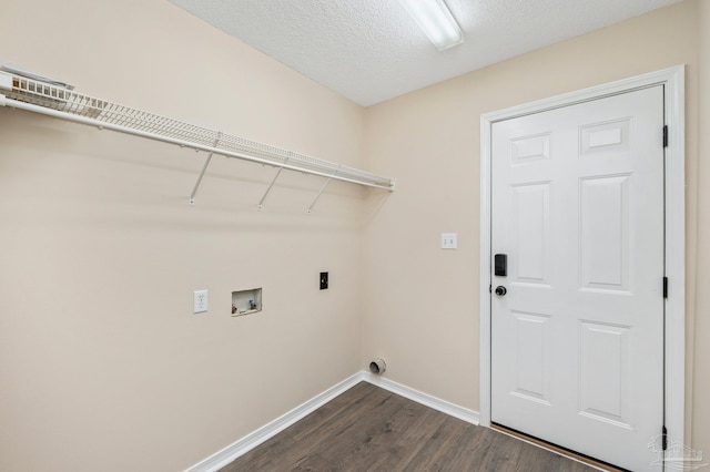 clothes washing area with dark hardwood / wood-style floors, washer hookup, hookup for an electric dryer, and a textured ceiling