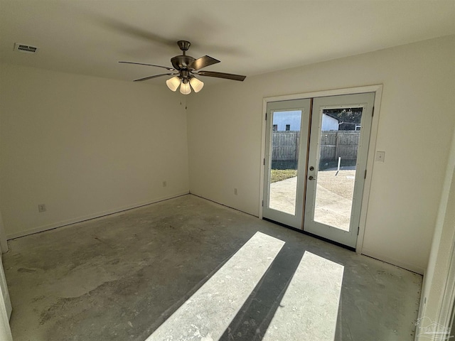 spare room with concrete flooring, french doors, and ceiling fan