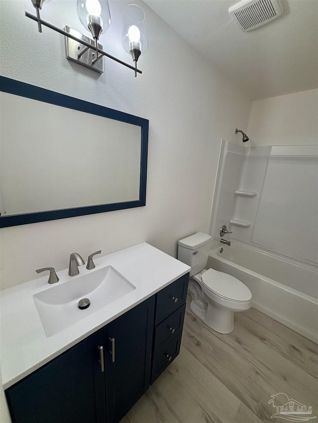 full bathroom featuring shower / bathing tub combination, vanity, toilet, and wood-type flooring