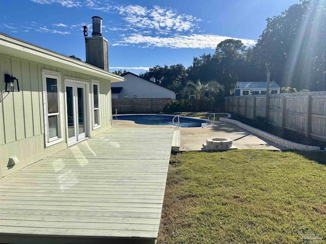 view of pool with a patio area, a yard, and an outdoor fire pit