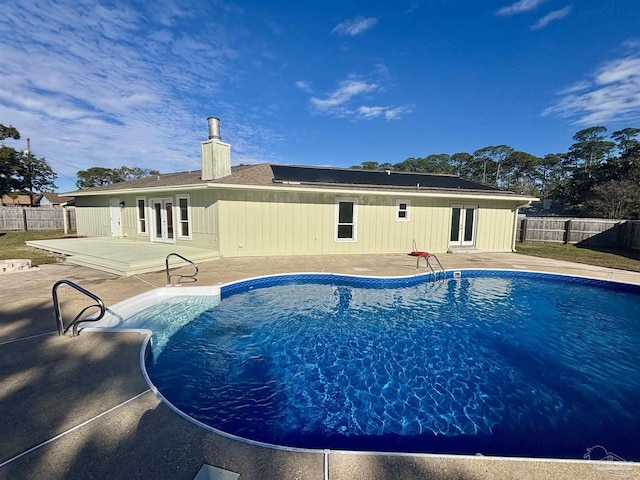 view of swimming pool with a patio area and french doors