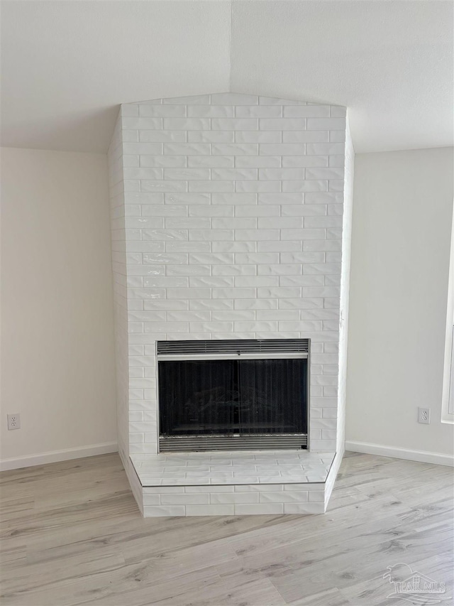 interior details with hardwood / wood-style flooring and a fireplace