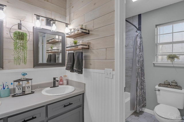 full bathroom with toilet, shower / tub combo with curtain, vanity, and wooden walls