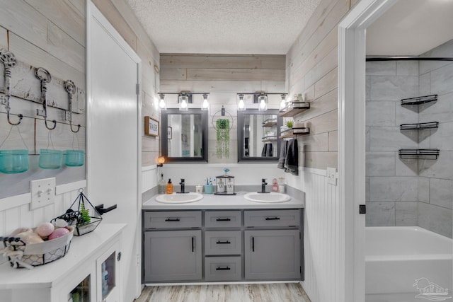 bathroom with a textured ceiling and wooden walls