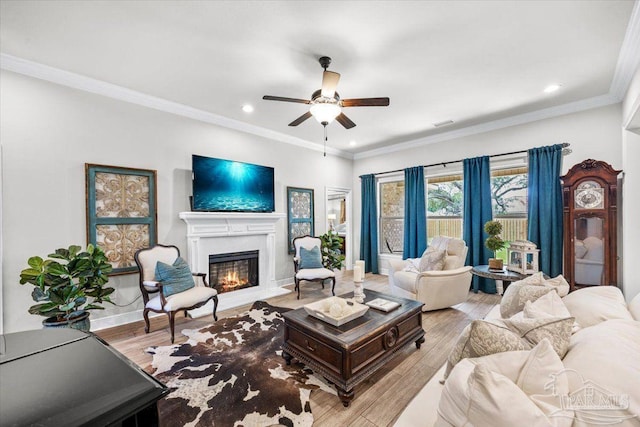 2219 River Birch Rd, Gulf Breeze, FL 32563 - living room featuring ceiling fan, a lit fireplace, wood finished floors, recessed lighting, and crown molding