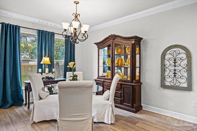 2219 River Birch Rd, Gulf Breeze, FL 32563 - dining room with a chandelier, wood finished floors, ornamental molding, and baseboards
