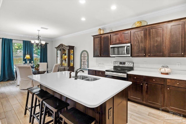 2219 River Birch Rd, Gulf Breeze, FL 32563 - kitchen featuring appliances with stainless steel finishes, a sink, a chandelier, light countertops, and ornamental molding