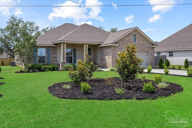 2219 River Birch Rd, Gulf Breeze, FL 32563 - view of front of house with brick siding, a garage, a front yard, central AC, and a shingled roof