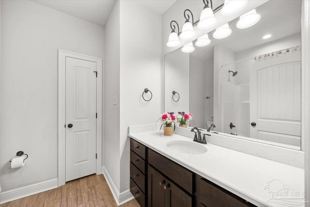 2219 River Birch Rd, Gulf Breeze, FL 32563 - bathroom with vanity, baseboards, a shower, and wood finished floors