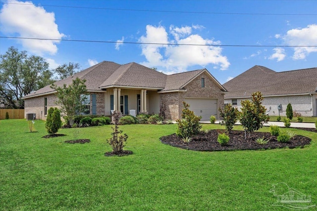 2219 River Birch Rd, Gulf Breeze, FL 32563 - view of front of home with a garage, a front yard, central air condition unit, and brick siding