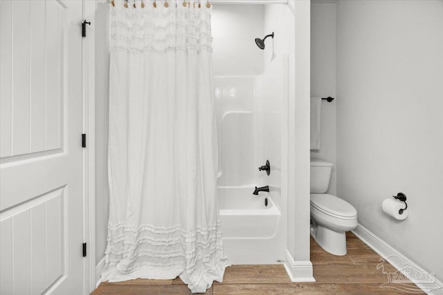2219 River Birch Rd, Gulf Breeze, FL 32563 - full bathroom with shower / bath combo, toilet, wood finished floors, and baseboards