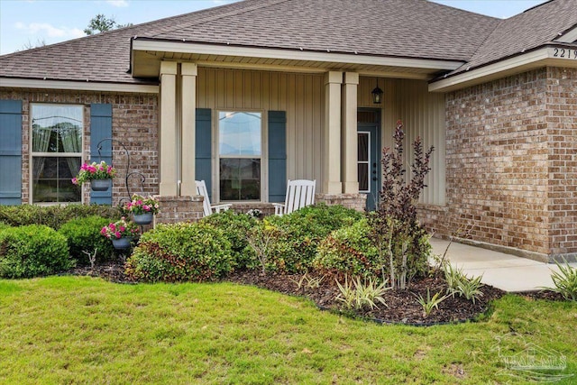2219 River Birch Rd, Gulf Breeze, FL 32563 - view of exterior entry featuring roof with shingles and brick siding