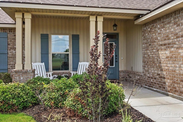2219 River Birch Rd, Gulf Breeze, FL 32563 - entrance to property featuring a shingled roof, covered porch, and brick siding