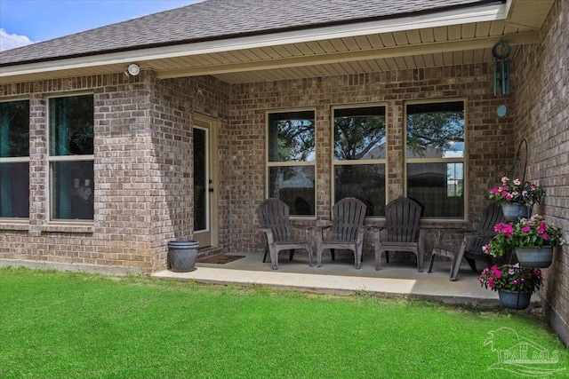 2219 River Birch Rd, Gulf Breeze, FL 32563 - back of house with brick siding, a shingled roof, and a lawn