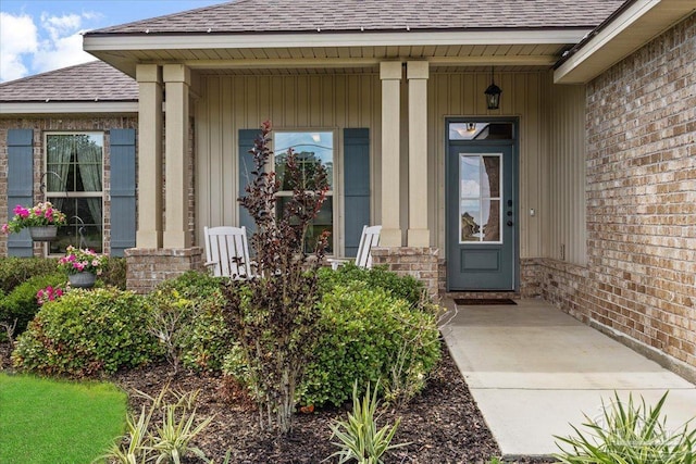 2219 River Birch Rd, Gulf Breeze, FL 32563 - entrance to property with roof with shingles, covered porch, and brick siding