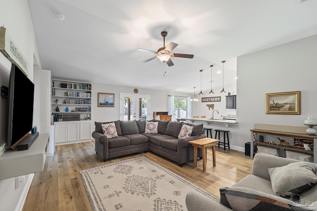 5613 Cane Syrup Cir, Pace, FL 32571 - living room featuring a ceiling fan, light wood-style floors, and baseboards