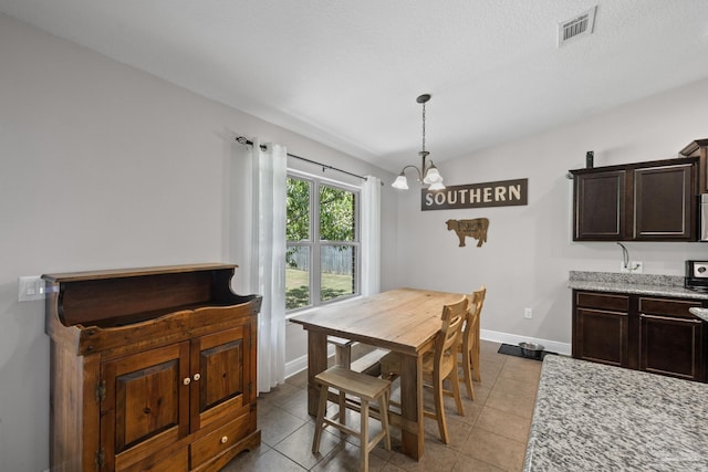 5613 Cane Syrup Cir, Pace, FL 32571 - dining room with a chandelier, tile patterned floors, baseboards, and lofted ceiling