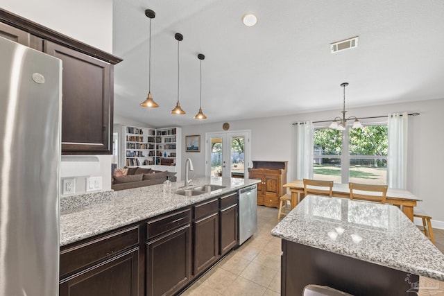 5613 Cane Syrup Cir, Pace, FL 32571 - kitchen featuring a sink, appliances with stainless steel finishes, dark brown cabinets, and a peninsula