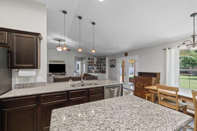 5613 Cane Syrup Cir, Pace, FL 32571 - kitchen with stainless steel appliances, a sink, dark brown cabinets, open floor plan, and a textured ceiling