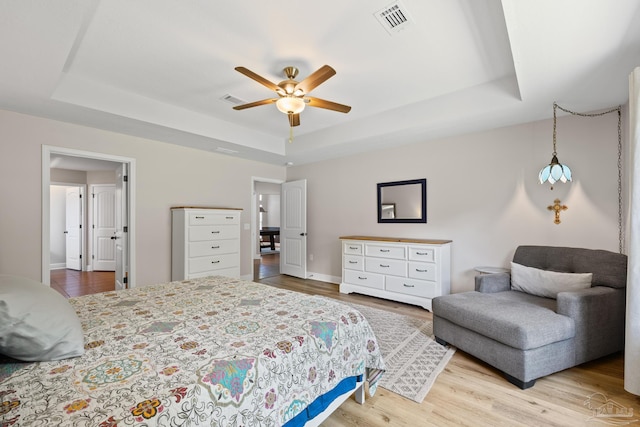 5613 Cane Syrup Cir, Pace, FL 32571 - bedroom with a tray ceiling, wood finished floors, baseboards, and ceiling fan