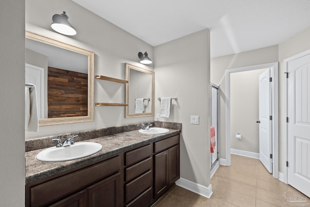 5613 Cane Syrup Cir, Pace, FL 32571 - full bathroom featuring a shower stall, double vanity, tile patterned flooring, and baseboards