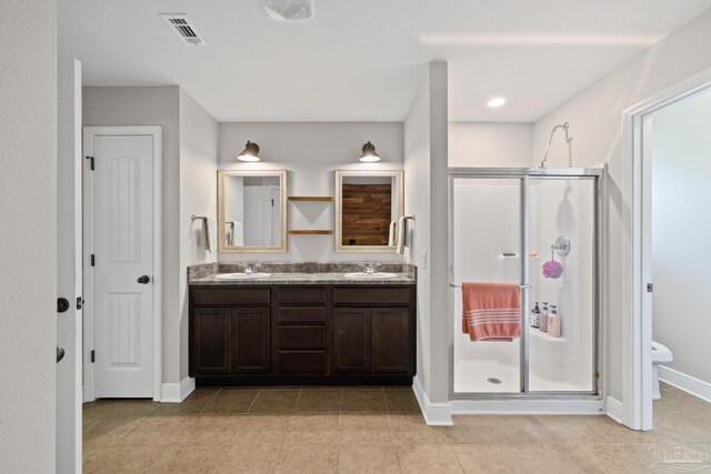5613 Cane Syrup Cir, Pace, FL 32571 - bathroom featuring double vanity, a shower stall, toilet, baseboards, and tile patterned flooring